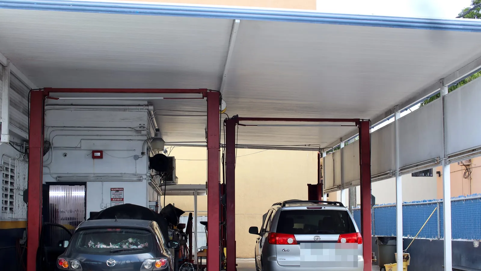 Service bays at Japanese Auto Tech in Miami, with cars up on the lifts